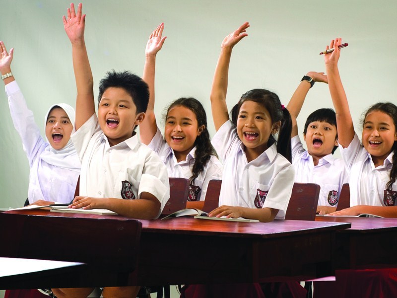 Group of children in a classroom looking engaged